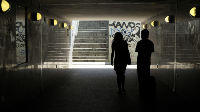 Two people in a subway tunnel