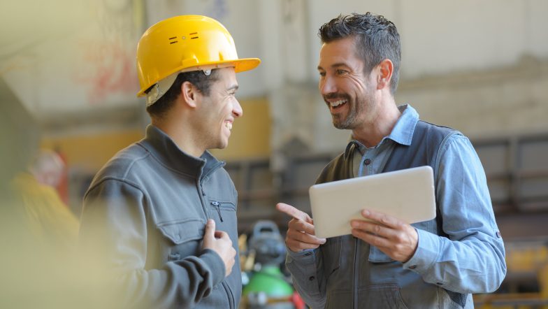 workers talking and laughing at a factory