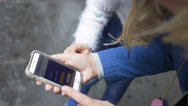 People looking at Justice Connect get help app on mobile